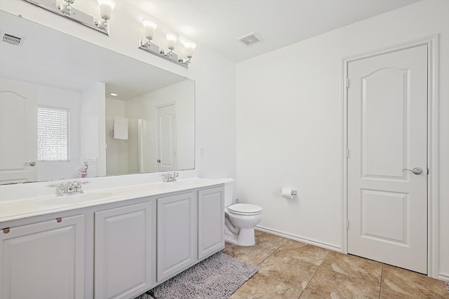 bathroom featuring tile patterned flooring, vanity, and toilet