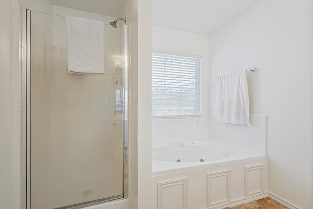 bathroom featuring shower with separate bathtub