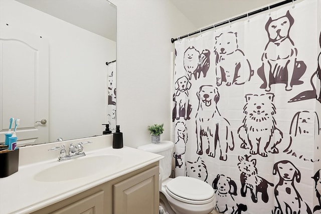 bathroom with vanity, toilet, and walk in shower