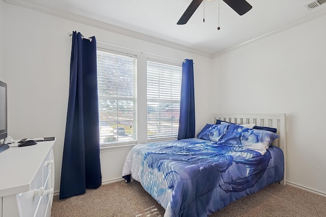 carpeted bedroom with multiple windows, crown molding, and ceiling fan