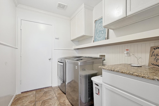 laundry area featuring cabinets, separate washer and dryer, and crown molding