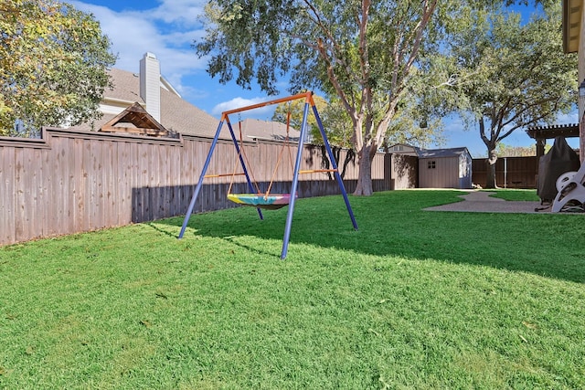 view of yard with a playground and a storage unit