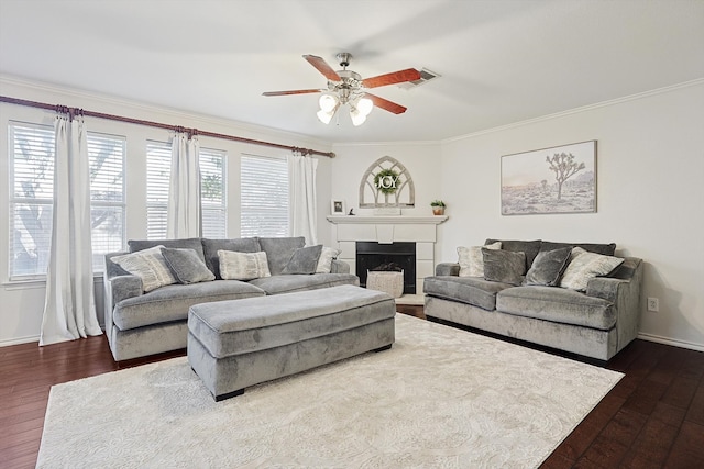 living room featuring dark hardwood / wood-style floors, ceiling fan, and crown molding