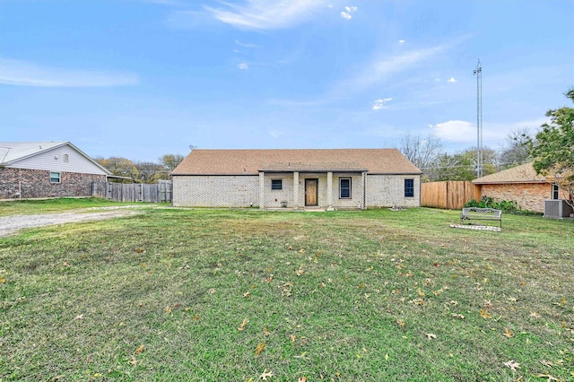 view of front of home with a front yard and central AC unit