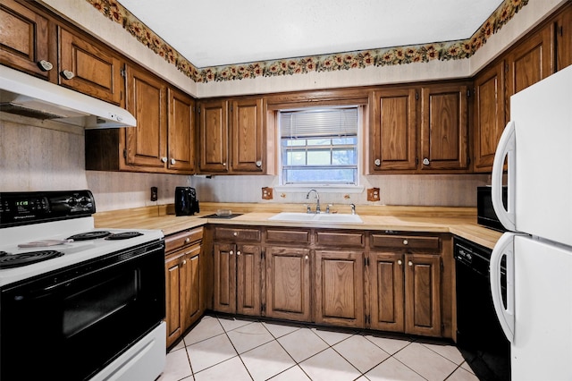 kitchen with white appliances, sink, and light tile patterned floors