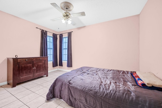 bedroom with ceiling fan and light tile patterned flooring