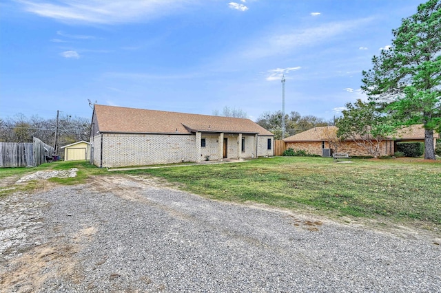 single story home with an outbuilding and a front lawn