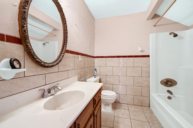 full bathroom with tile patterned flooring, shower / bath combination, toilet, vanity, and tile walls