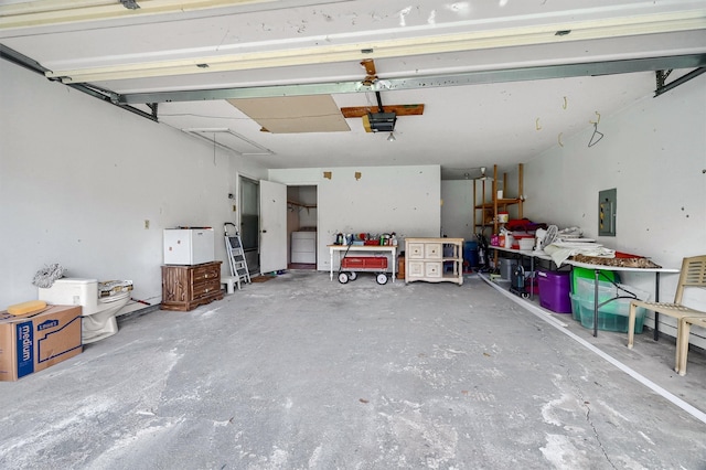 garage with electric panel and a garage door opener