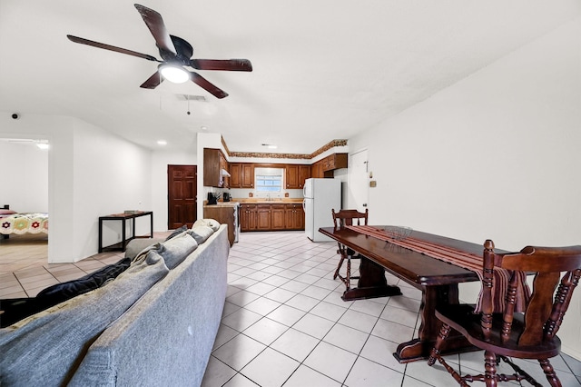 living room featuring sink, ceiling fan, and light tile patterned flooring