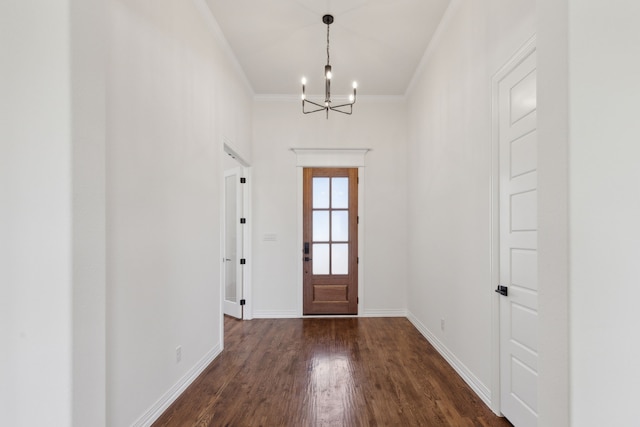 foyer with baseboards, an inviting chandelier, dark wood-style flooring, and crown molding