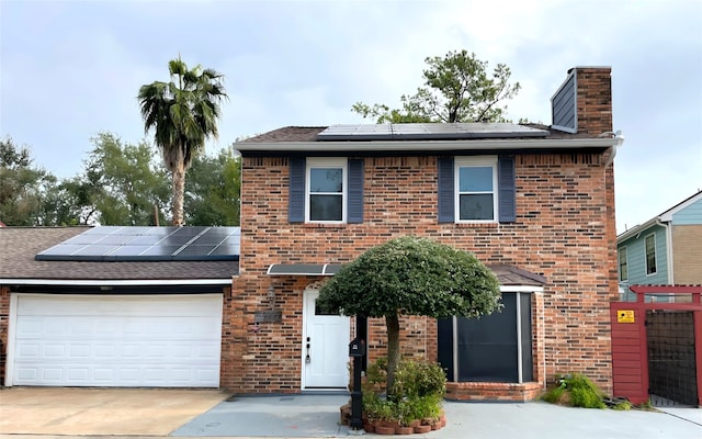 view of front of property featuring solar panels and a garage