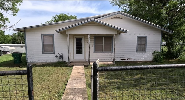 bungalow-style house with a front lawn and a porch