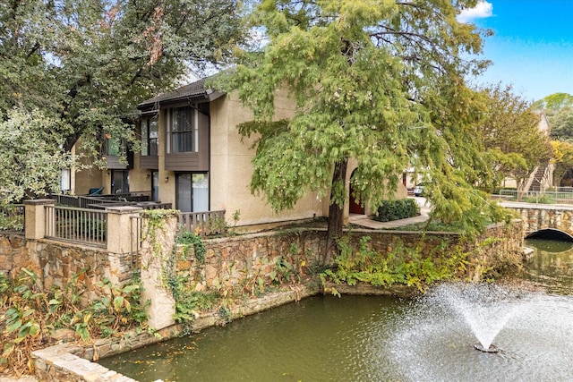 back of property with a water view