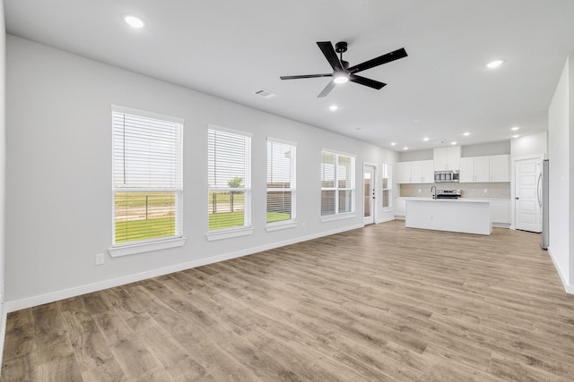 4016-4018 Clovis St, Midlothian, TX 76065 - unfurnished living room featuring recessed lighting, ceiling fan, light wood finished floors, baseboards, and a sink