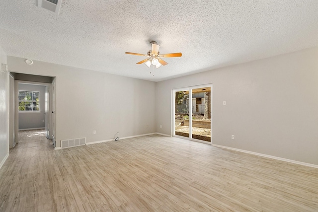 unfurnished room with a textured ceiling, light hardwood / wood-style floors, and ceiling fan