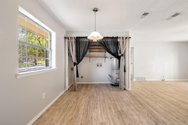 interior space with hardwood / wood-style floors and a textured ceiling