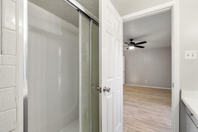 210 Skylark Dr, Azle, TX 76020 - bathroom featuring a shower stall, wood finished floors, vanity, ceiling fan, and baseboards