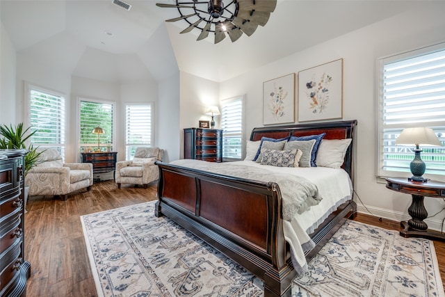 bedroom with hardwood / wood-style floors and vaulted ceiling