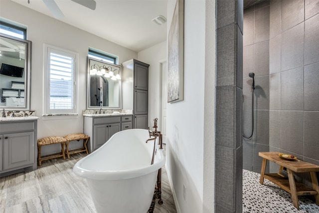 bathroom featuring vanity, ceiling fan, and independent shower and bath