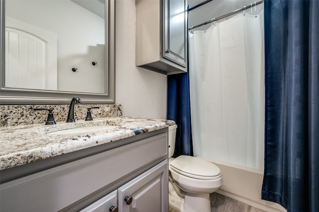 full bathroom with shower / bath combo with shower curtain, vanity, and toilet