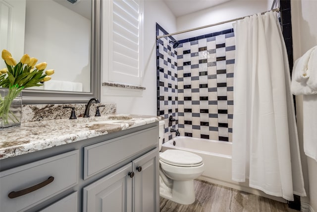 full bathroom featuring wood-type flooring, vanity, toilet, and shower / bath combo