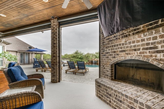 view of patio with ceiling fan and an outdoor brick fireplace