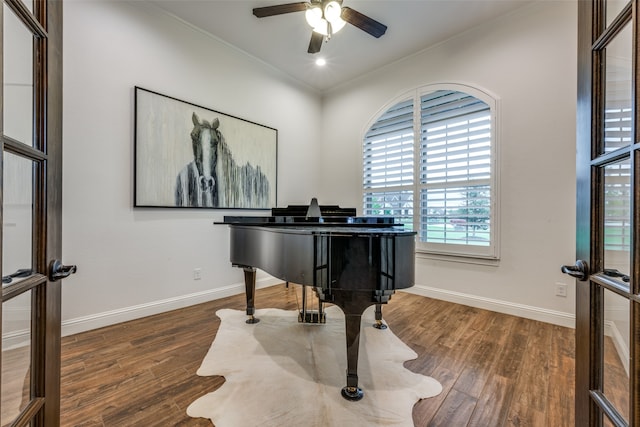 interior space featuring dark hardwood / wood-style floors, ceiling fan, ornamental molding, and french doors