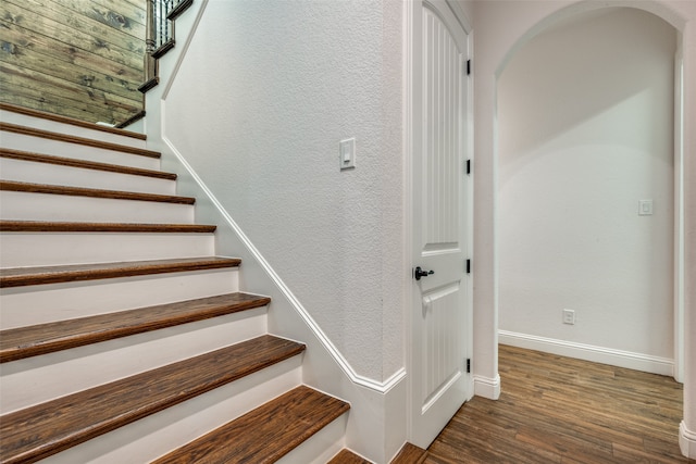 stairway with hardwood / wood-style floors