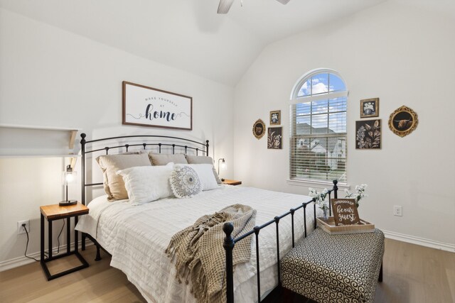 bedroom with light wood-type flooring, ceiling fan, and vaulted ceiling