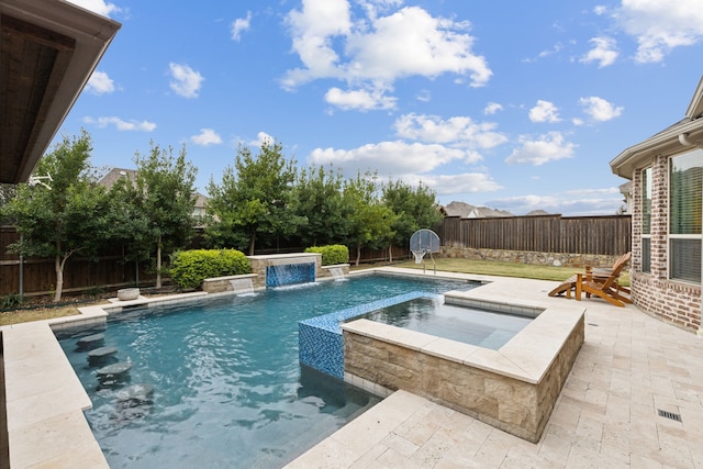 view of swimming pool featuring pool water feature, a patio area, and an in ground hot tub