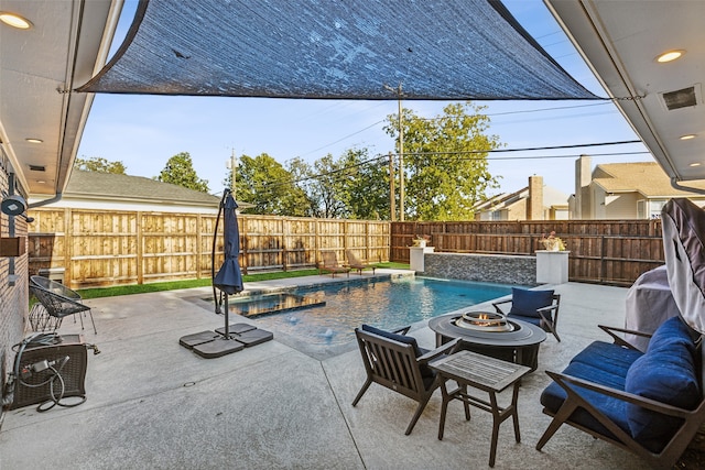 view of swimming pool with pool water feature, a patio, and an outdoor fire pit