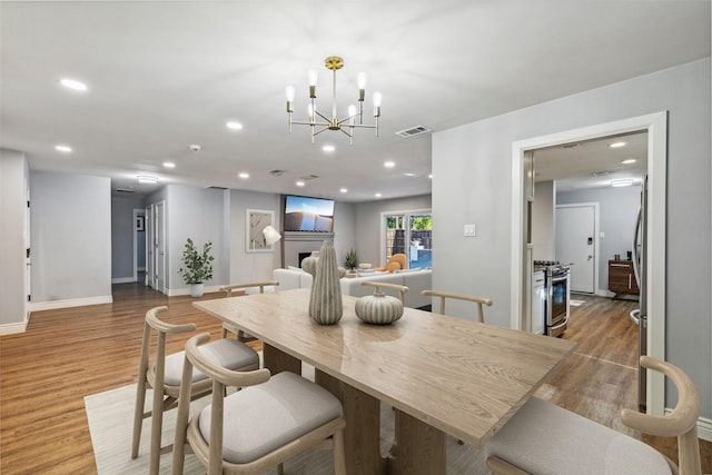 dining room featuring hardwood / wood-style floors and a chandelier