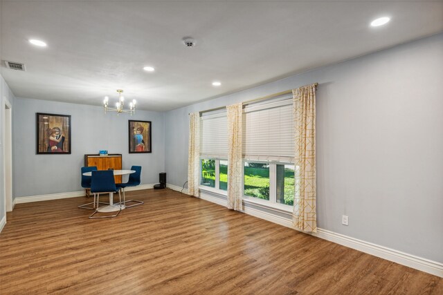 interior space with a chandelier and light hardwood / wood-style floors