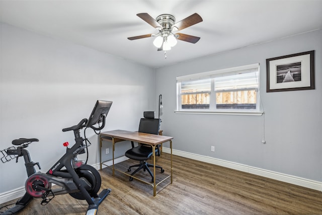 home office with wood-type flooring and ceiling fan