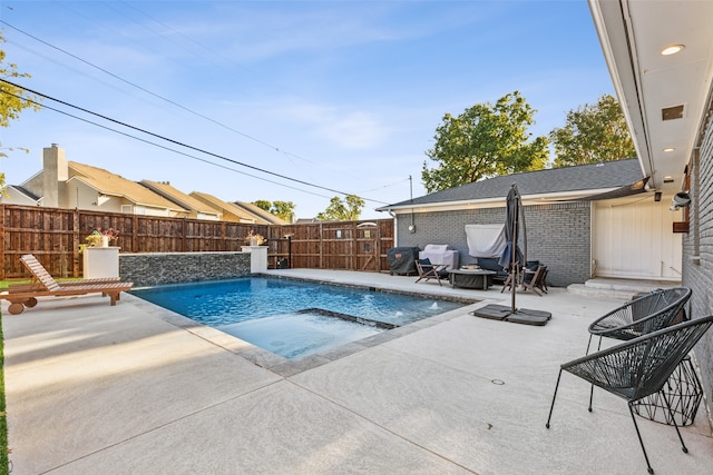 view of pool featuring a patio area and a hot tub