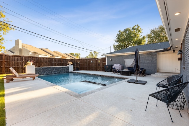 view of pool with a jacuzzi and a patio