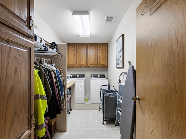 laundry room with cabinets and washer and dryer