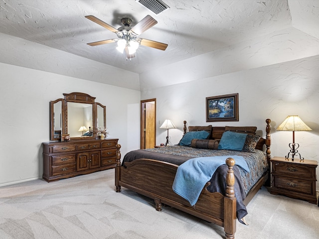 carpeted bedroom with ceiling fan, a textured ceiling, and vaulted ceiling