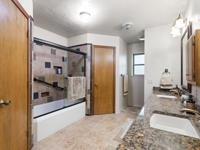 bathroom with shower / bath combination with glass door and vanity