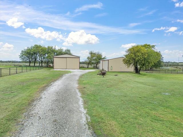 view of yard featuring an outbuilding and a rural view