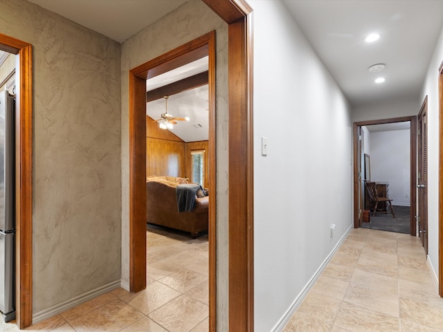 hall featuring lofted ceiling