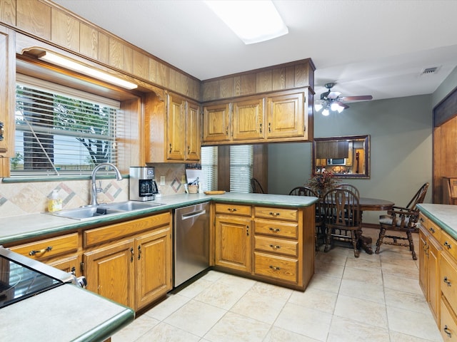 kitchen with tasteful backsplash, ceiling fan, sink, light tile patterned floors, and dishwasher