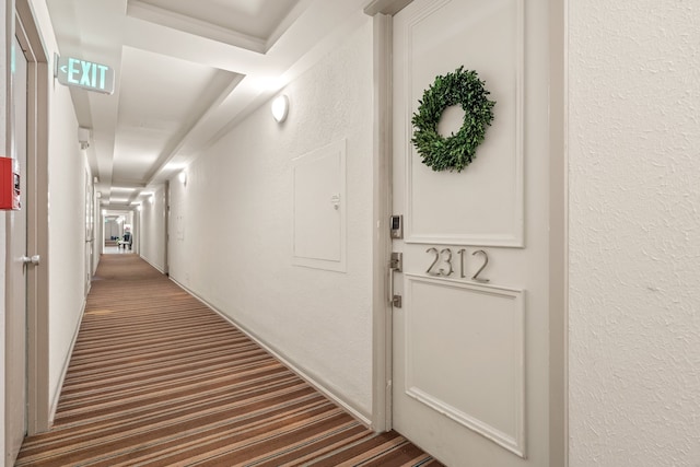 hallway featuring dark carpet