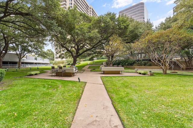 view of home's community featuring a yard and a patio