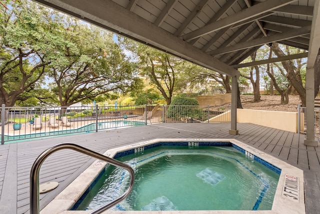 view of swimming pool with a hot tub