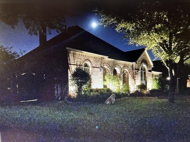 view of property exterior at night