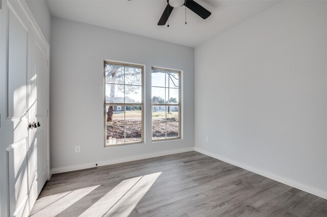 empty room featuring light wood-type flooring and ceiling fan