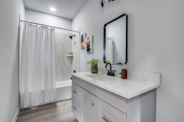 bathroom featuring vanity, wood-type flooring, and shower / bathtub combination with curtain