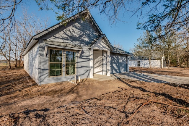 exterior space with driveway and an attached garage